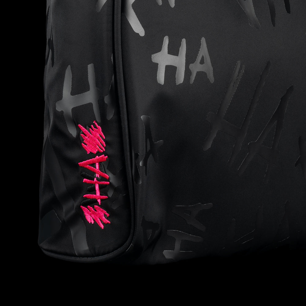 Close-up of SWAG Golf Defaced shoe bag with gray graffiti and an embroidered pink HA logo.