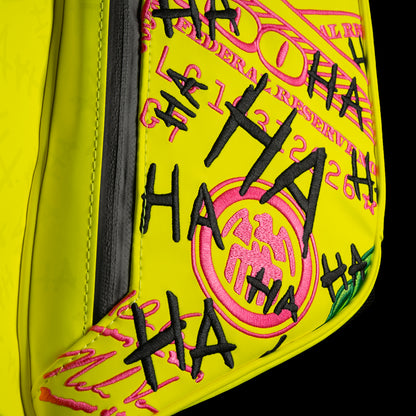 SWAG Golf x Vessel VLS Lux golf stand bag with neon yellow material and embroidered Defaced Franklin design on pink dollar bill themed panels. 