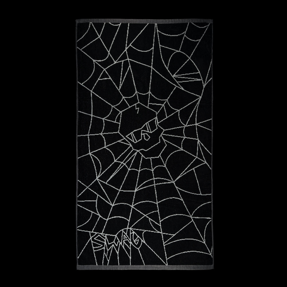 SWAG Golf Spider Web golf towel in black with gray spiderweb artwork, a central skull emblem, and spider web SWAG lettering.