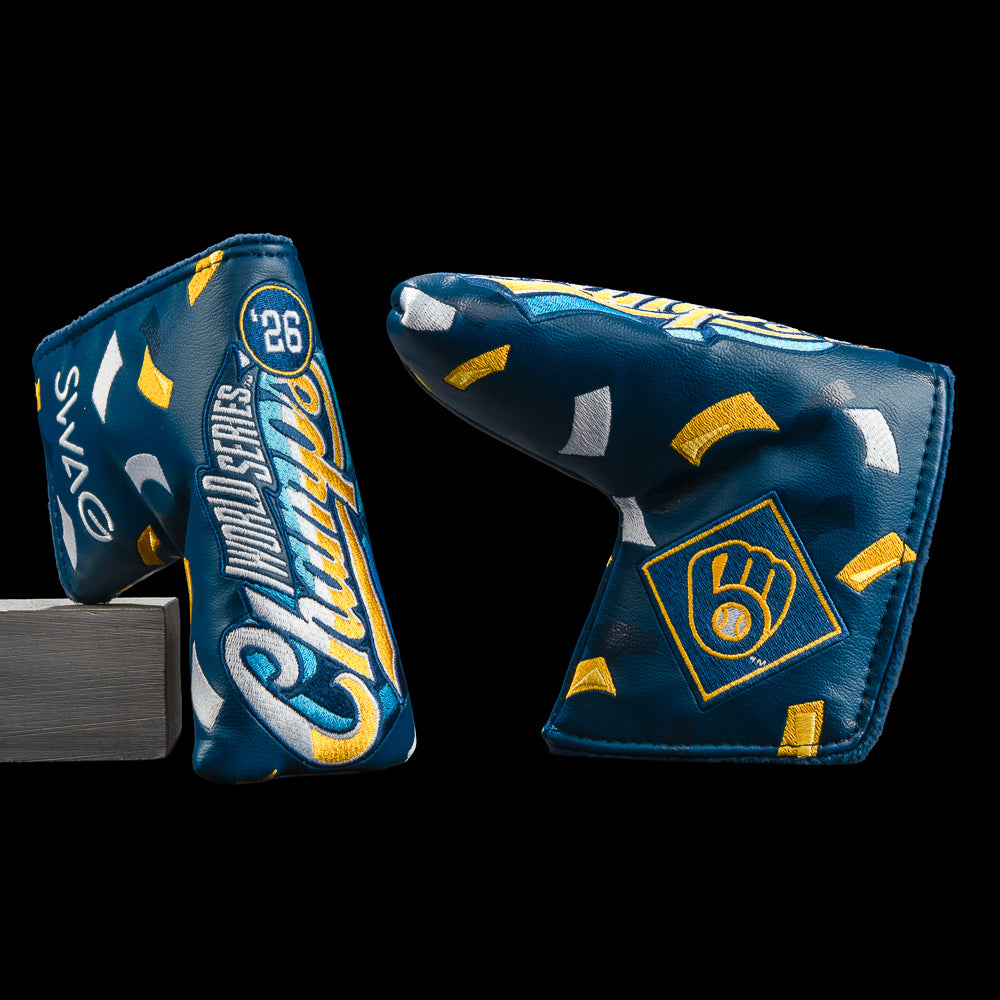 Two blue golf putter headcovers with yellow and white Milwaukee Brewers-themed graphics, including 'Champions' script, a number 26 badge, and a Brewers logo, shown on a black background.