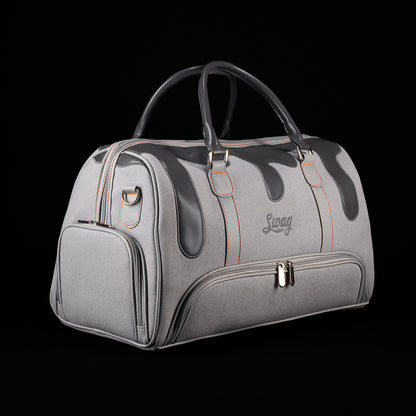 Angled view of SWAG Golf Dripping Duffle Bag featuring grey construction, black drip graphics, and multiple storage pockets.
