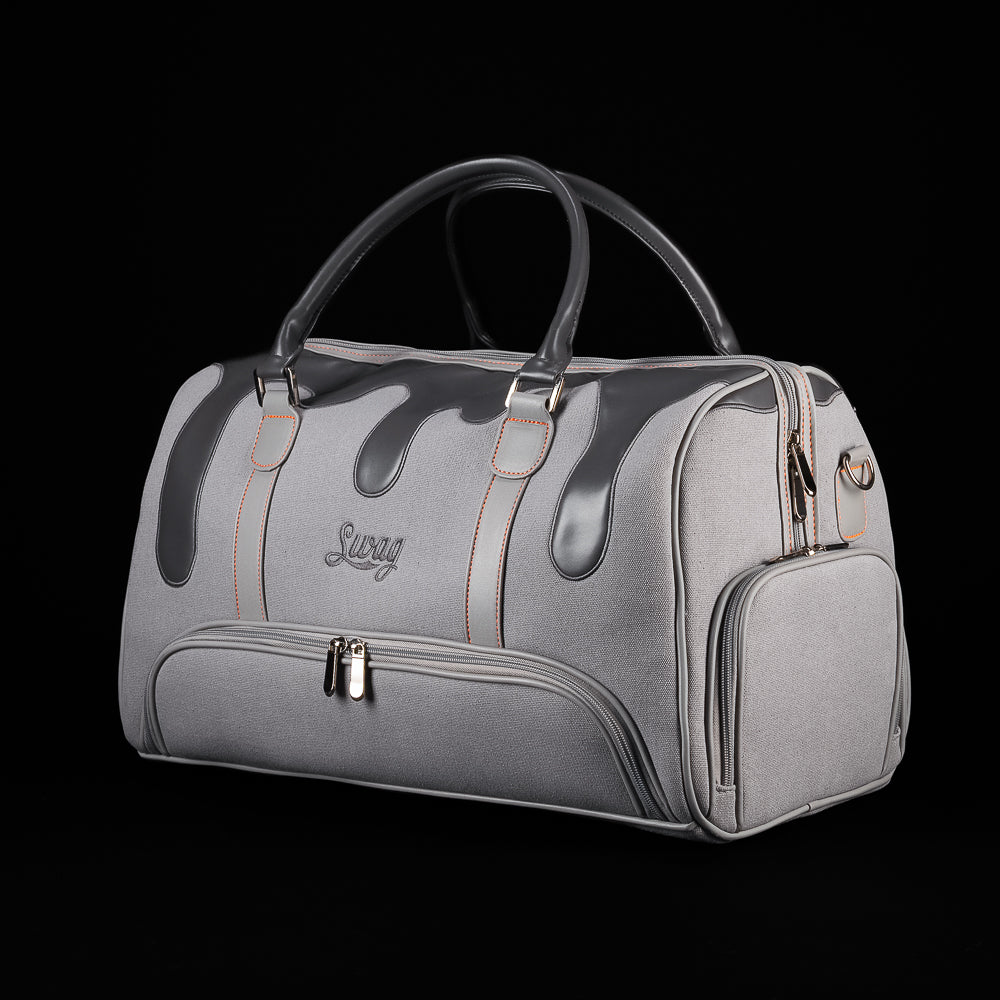 SWAG Golf Dripping Duffle Bag in grey with black drip design, orange stitching, dual handles, and front zip pocket.
