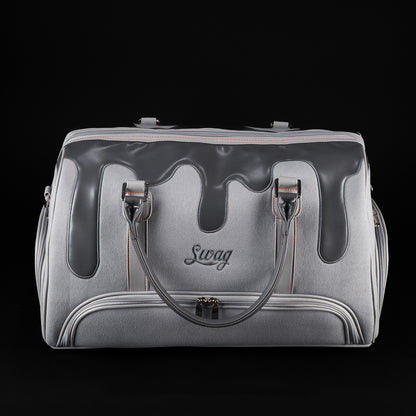 Front view of SWAG Golf Dripping Duffle Bag featuring grey body, black drip accents, embroidered SWAG logo, and zipper pocket.