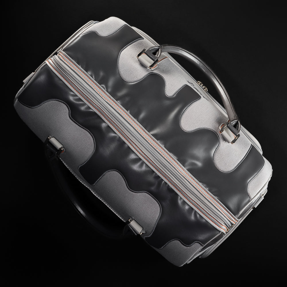 Top view of SWAG Golf Dripping Duffle Bag with black drip panel, dual zipper closure, and reinforced leather handles.