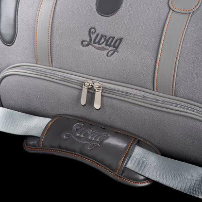 Close-up of SWAG Golf Dripping Duffle Bag zipper pocket and strap pad with embroidered SWAG logo and premium stitching details.
