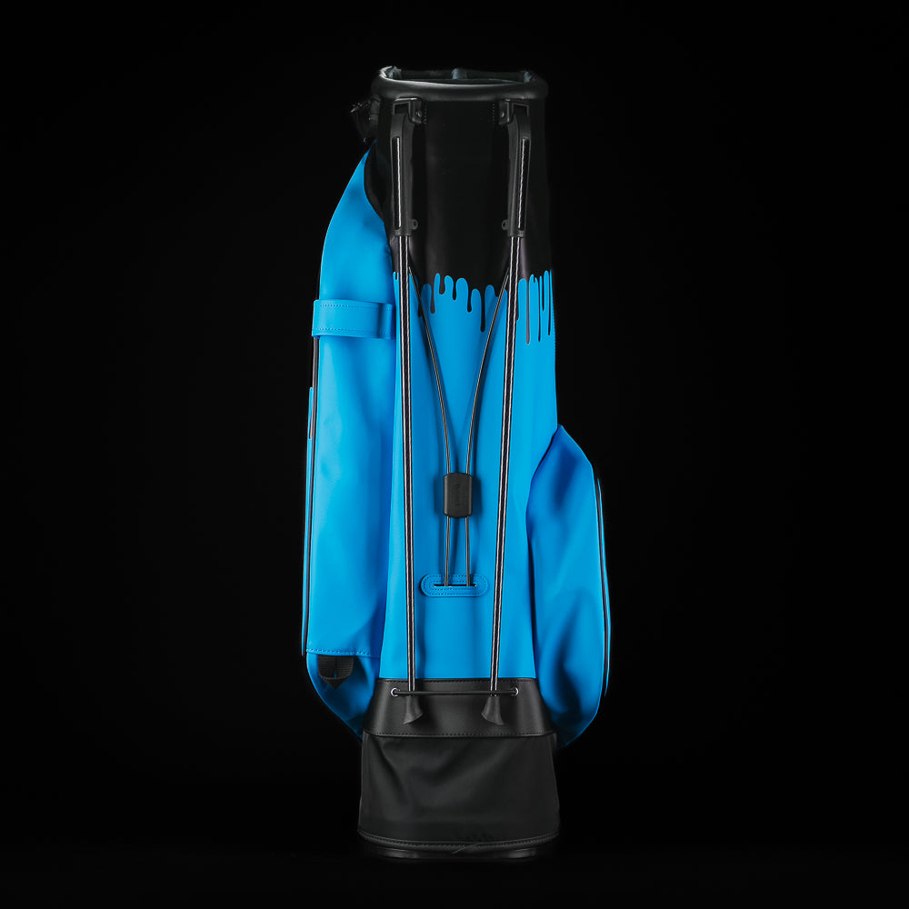 Blue and black SWAg Golf x Vessel golf stand bag with 'Don't Give a Putt' and 'Swag' text on a black background