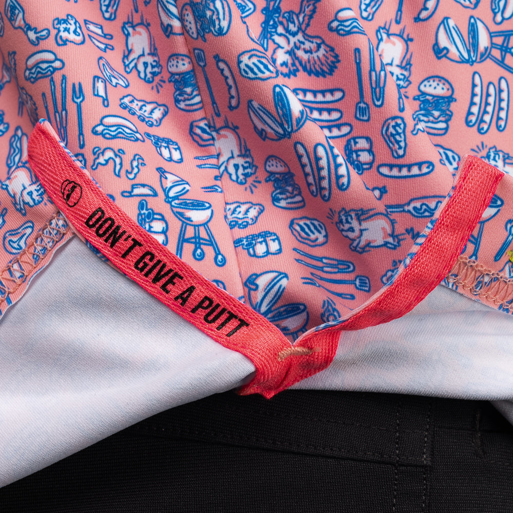 Interior detail of SWAG Golf Backyard BBQ Classic Polo featuring signature Don't Give A Putt embroidery tape in bold pink accent color and custom cookout-inspired pattern interior