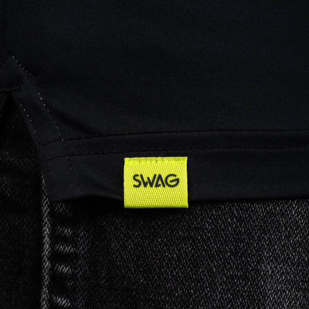 SWAG Golf Black Skull Classic Polo hem detail with signature SWAG woven tag on performance golf shirt