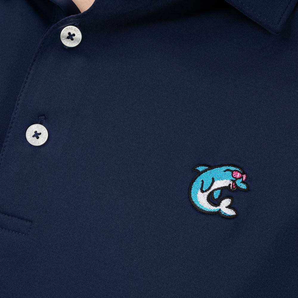 Close-up of embroidered Flipper dolphin logo on SWAG Golf Navy Flipper Classic Polo performance golf shirt
