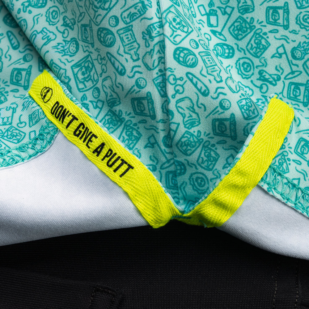 Interior detail of SWAG Golf On The Rocks Classic Polo featuring signature Don't Give A Putt embroidery tape in high-visibility neon accent color