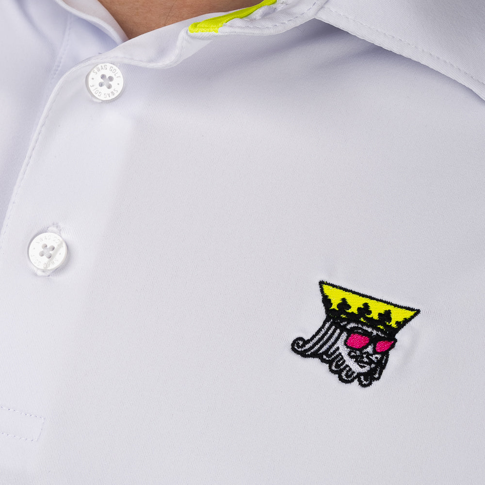 Close-up of embroidered King logo on SWAG Golf White King Classic Polo performance golf shirt featuring crown and sunglasses graphic