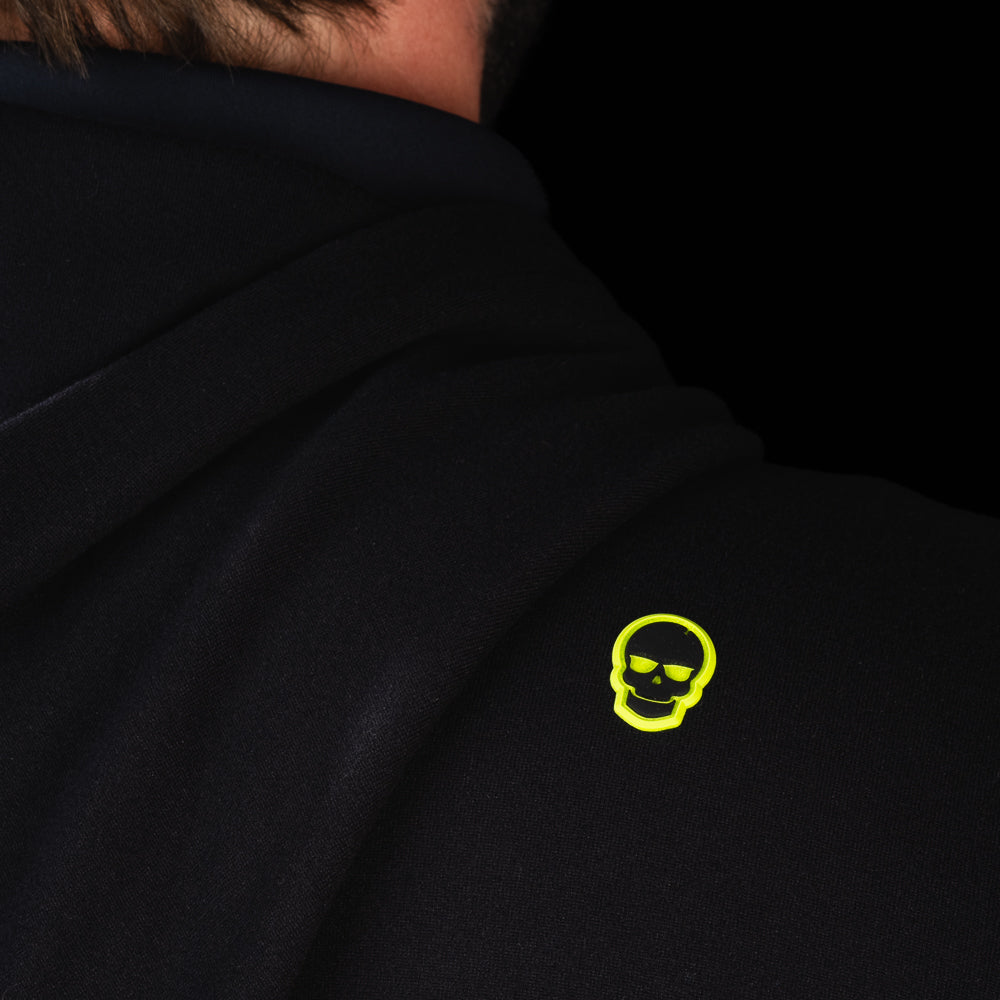Back shoulder detail of SWAG Golf Black Lounge Hoodie featuring the signature neon skull logo