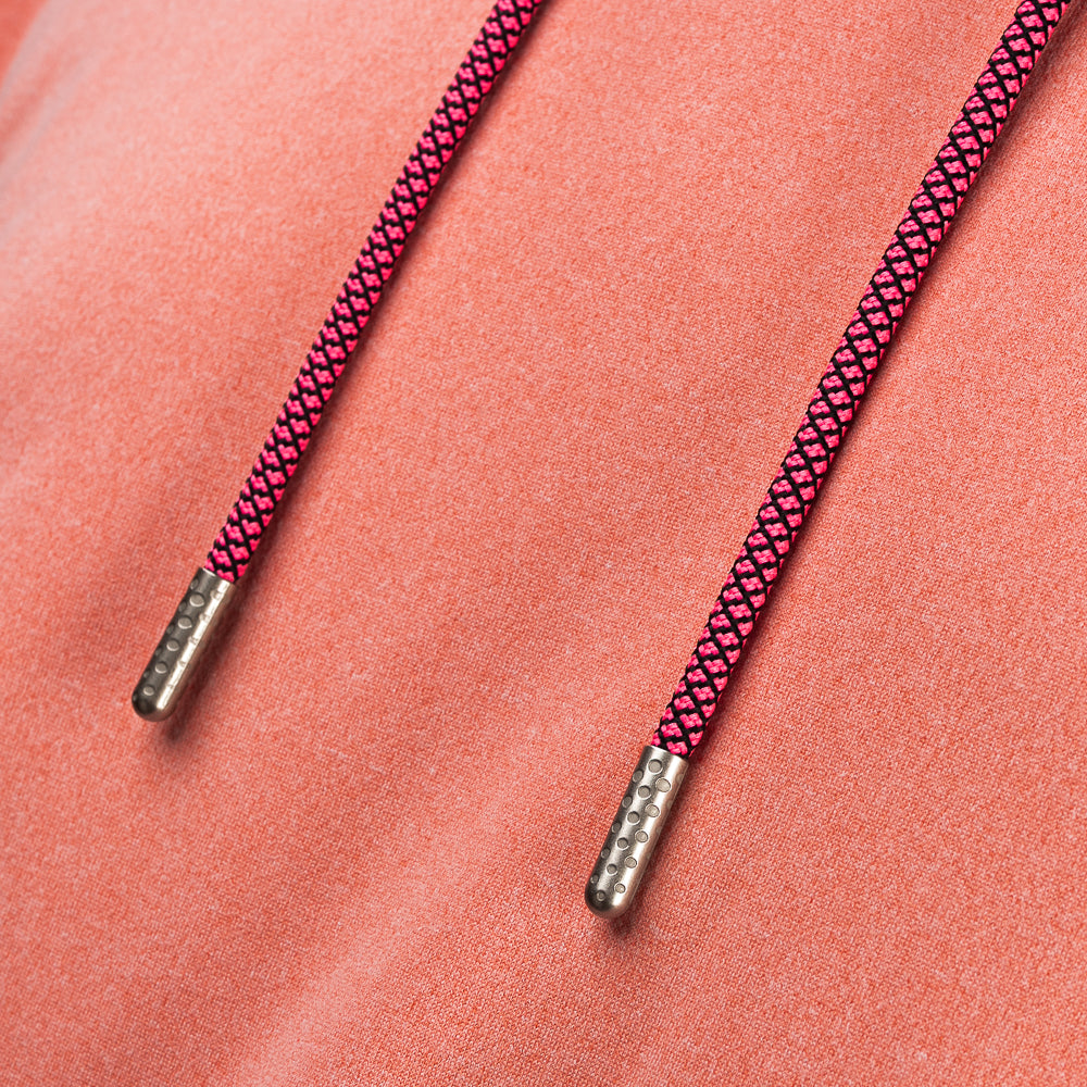 Close-up of pink braided drawstrings with metal tips on the SWAG Golf Heathered Peach Lounge Hoodie