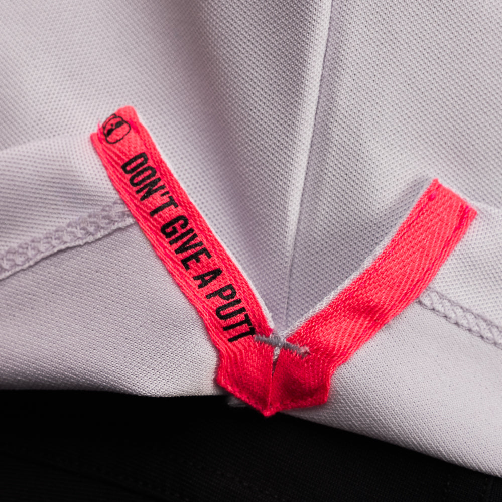 Interior detail of SWAG Golf Lavender Script Tech Polo featuring signature Don't Give A Putt embroidery tape in bold pink contrast.