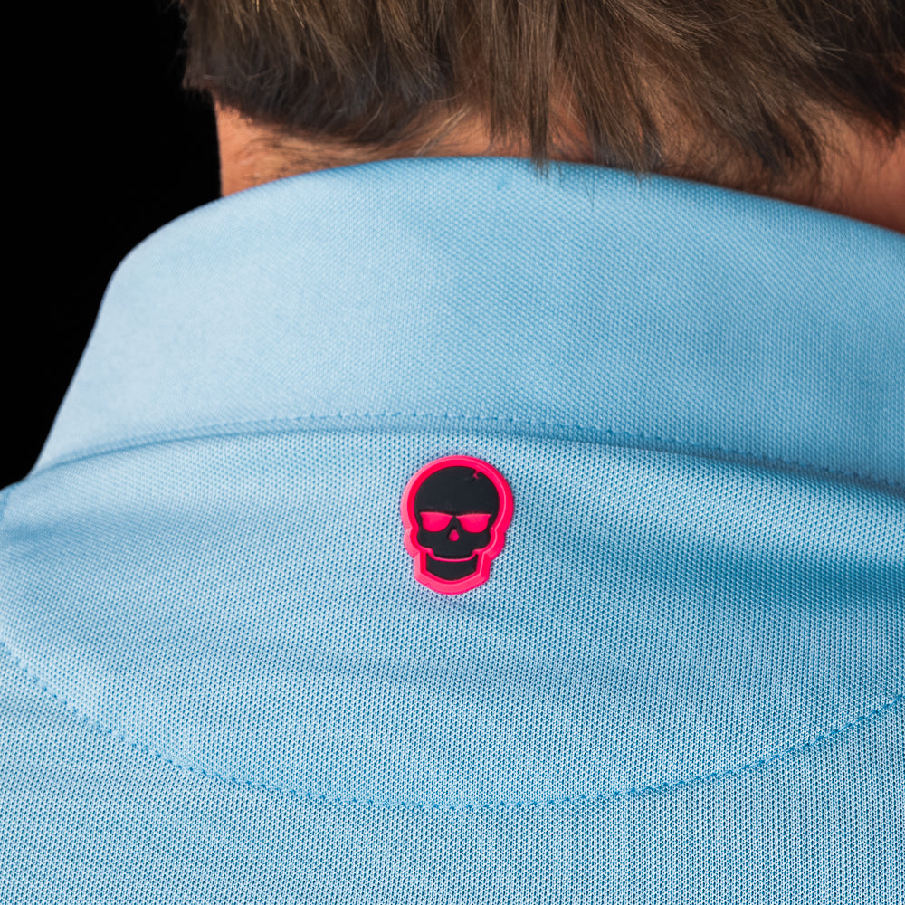 SWAG Golf Sky Blue Script Tech Polo back collar detail featuring the signature pink skull logo beneath the collar.