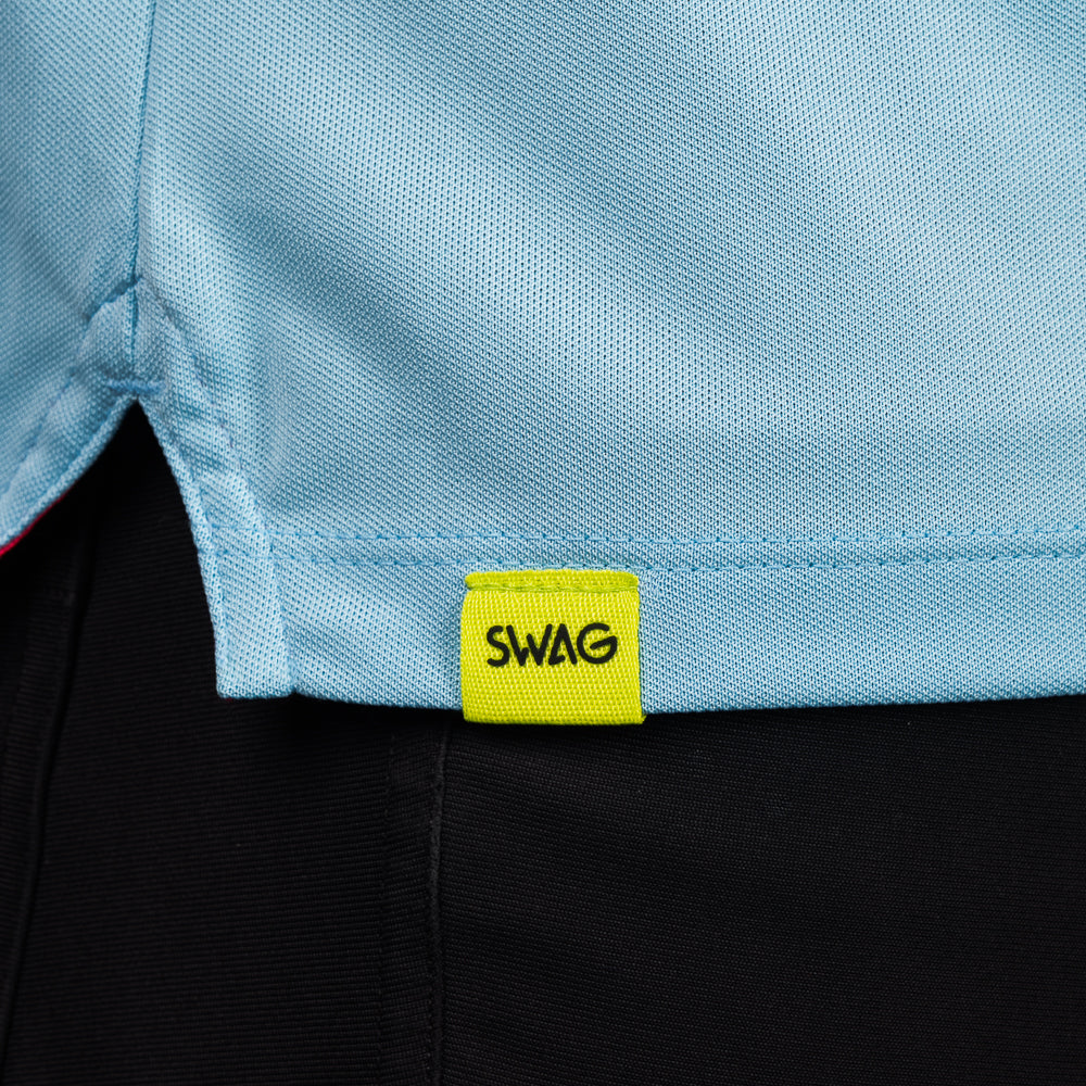 SWAG Golf Sky Blue Script Tech Polo hem detail featuring the signature neon SWAG woven tag.