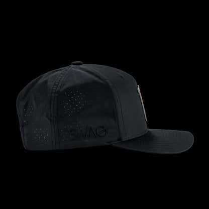 Black performance golf hat with a colorful bourbon glass skull graphic rubber patch on a black background
