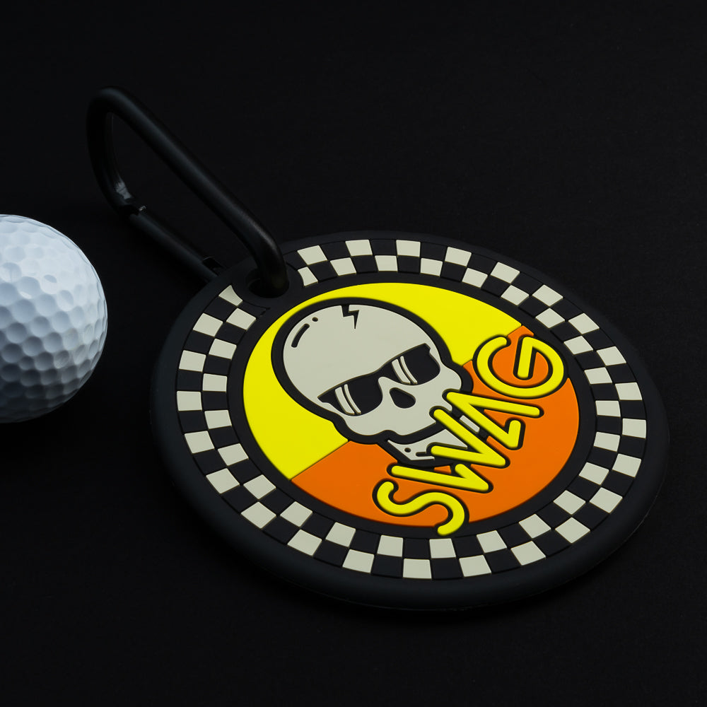 Swag Golf checkered orange and yellow skull golf putting disc accessory.