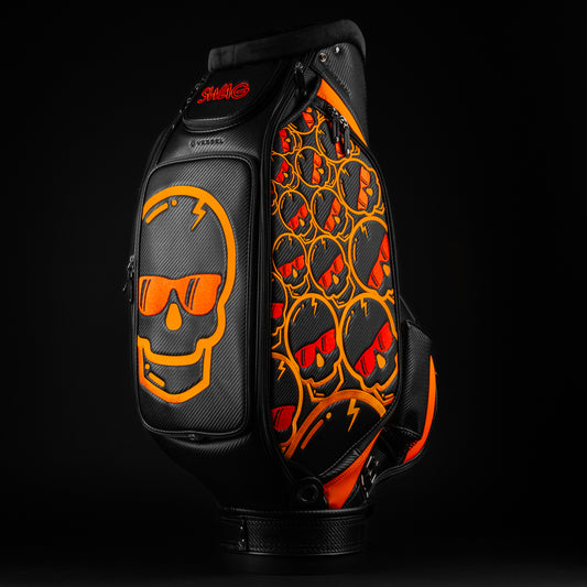 Swag x Vessel tour staff black golf bag with orange and red skull designs.