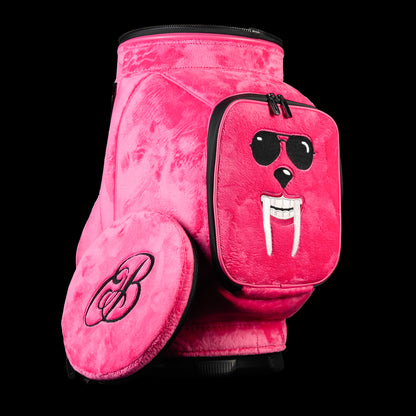 Pink plush SWAG Golf den caddy cooler with embroidered booster face pocket, black trim, and side logo detailing.