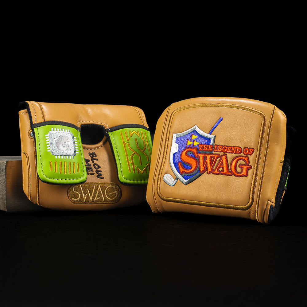 SWAG Golf gold center shaft mallet cover styled like a retro cartridge with Ocarina of SWAG artwork and "BLOW ME!" detailing.