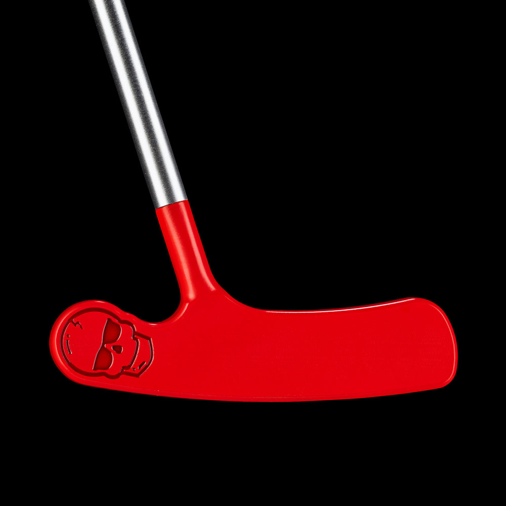 Side view of the red Putt-Putt Squirt blade putter highlighting the smooth red finish and engraved aviator skull.
