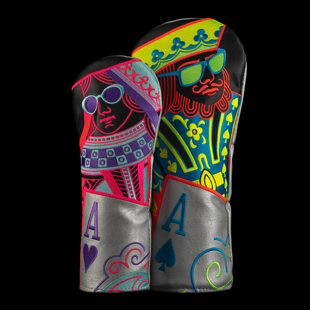 Two neon colored SWAG Golf headcovers featuring sherbet-toned king and queen playing-card designs on a black background.