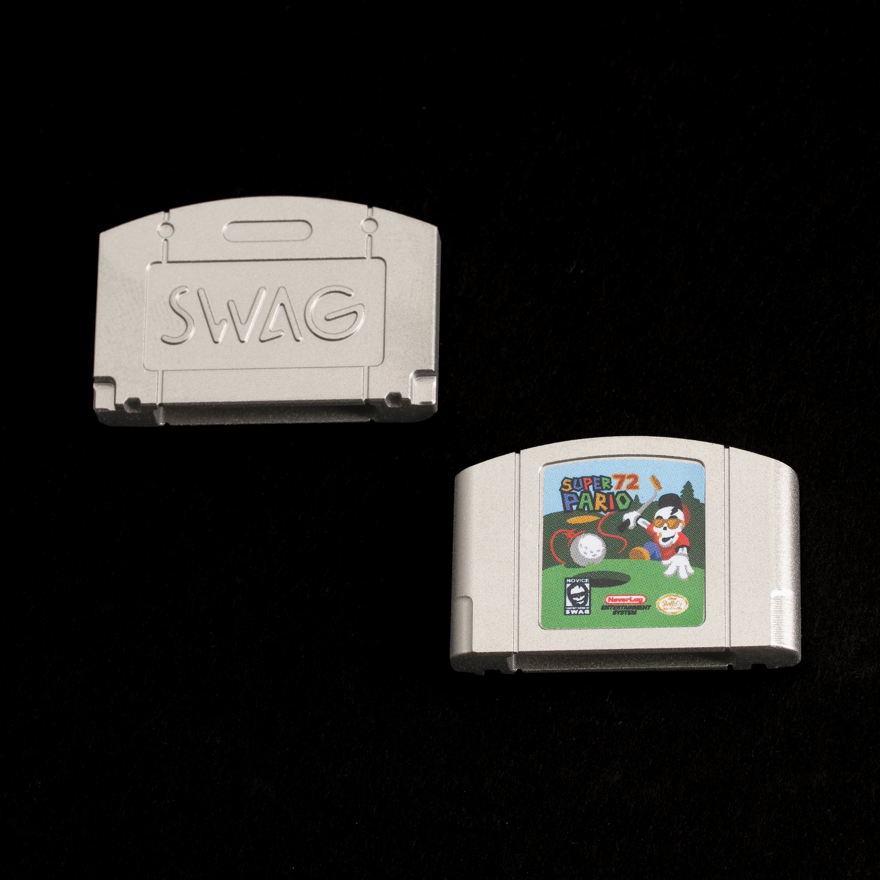 Stainless steel ball marker shaped like a retro cartridge with Super Pario 72 artwork and SWAG logo.