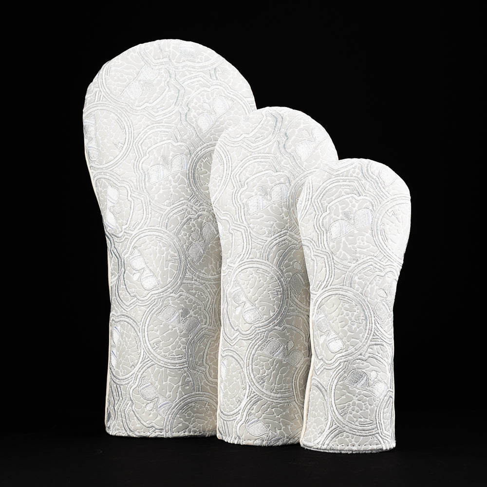 Textured white stacked-skull wood cover set including driver, fairway, and hybrid in icy monochrome White Elephant colorway.