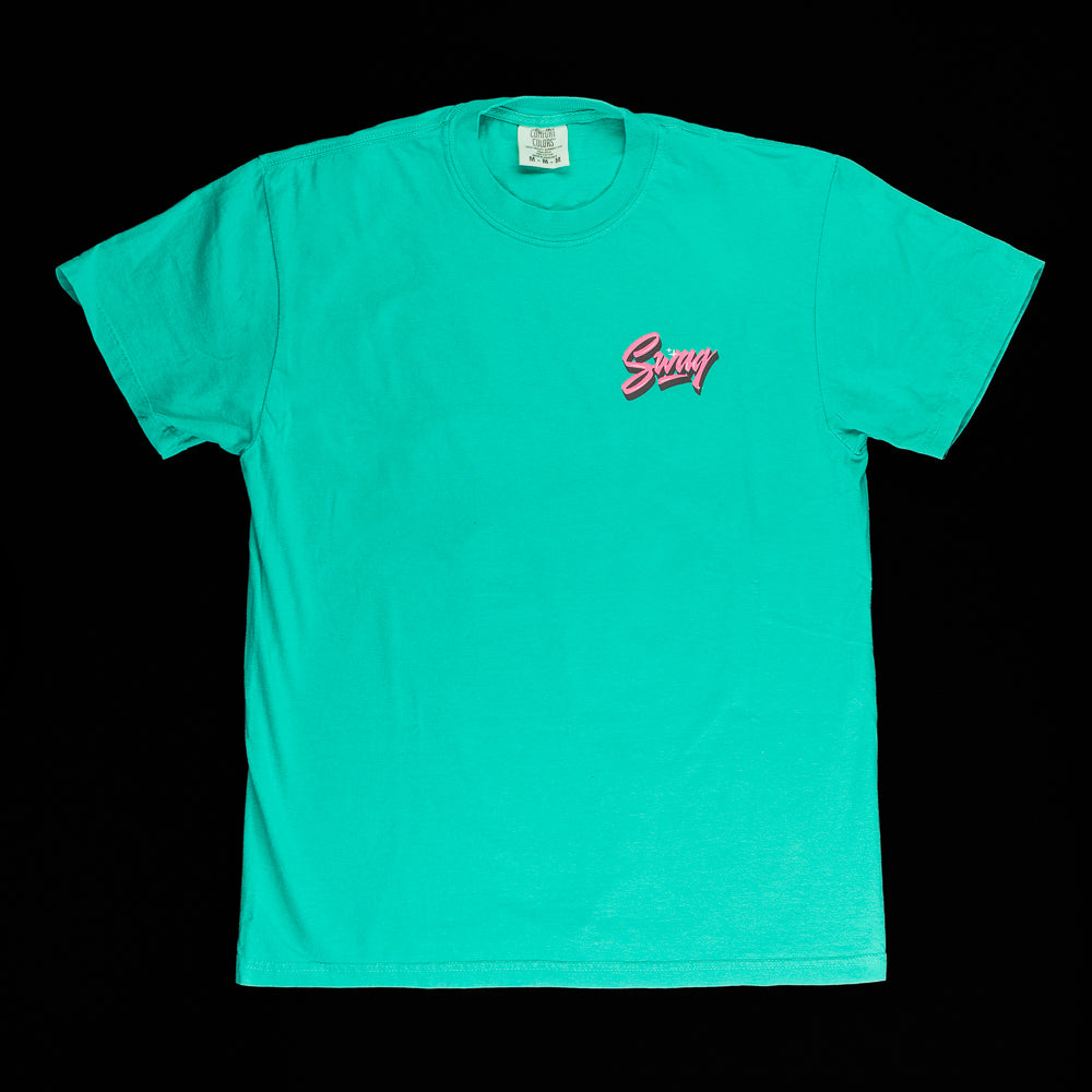 SWAG Golf x Comfort colors men's green short sleeve graphic t-shirt featuring flipper in Vice Beach setting.