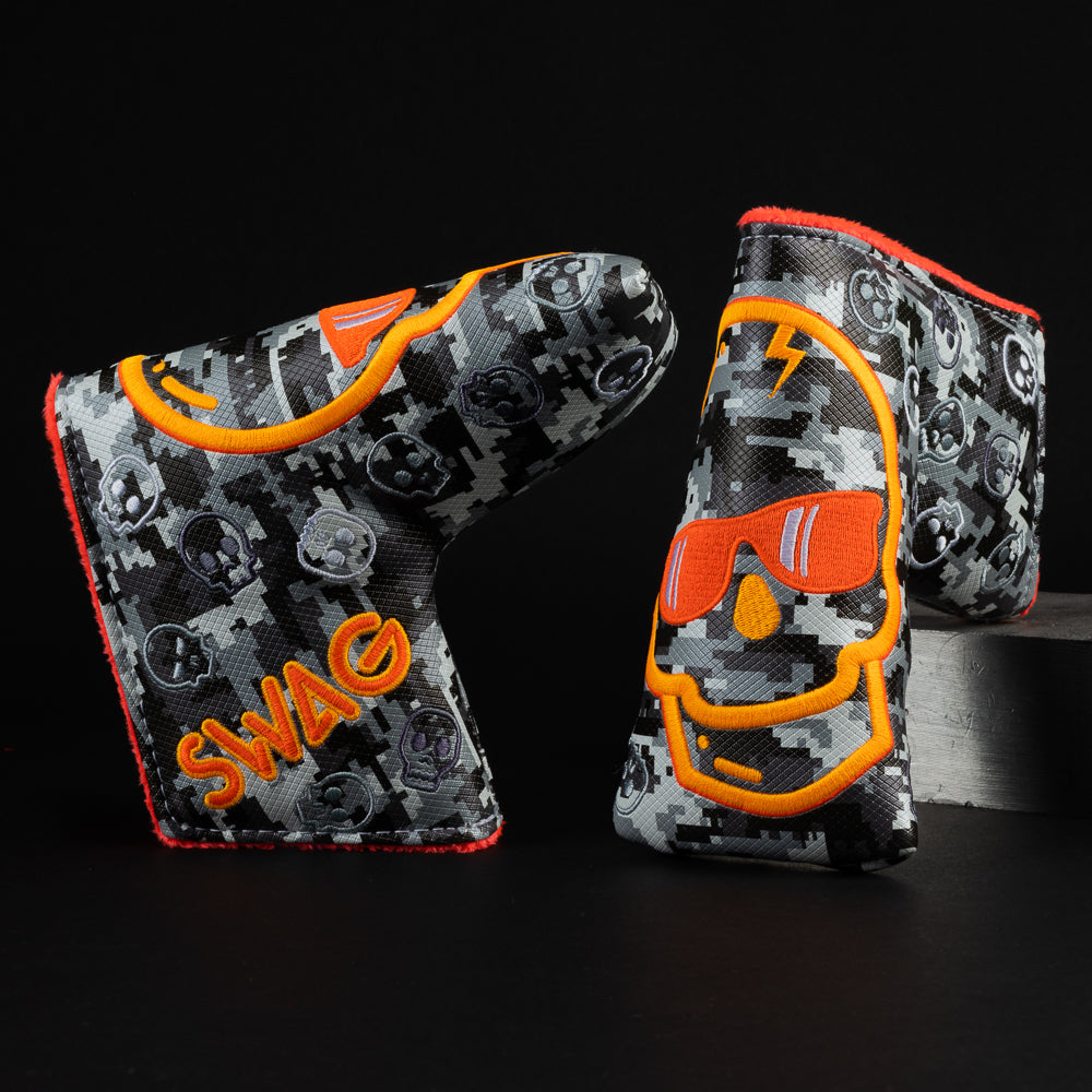 Digi skull black and gray digi print with an orange embroidered skull blade putter golf club head cover made in the USA.