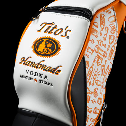 Close-up of the SWAG Golf x Tito's Bottle Caddy featuring Tito's Handmade Vodka artwork and the orange cocktail icon pattern.