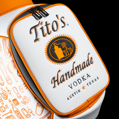 Close-up of the SWAG Golf Tito's Den Caddy Cooler zipper pocket featuring Tito's Handmade Vodka artwork and orange trim.