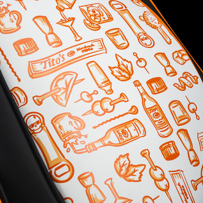 Close-up of the SWAG Golf Tito's Den Caddy Cooler all-over pattern featuring illustrated cocktail glasses, bottles, citrus, and Tito's icons.