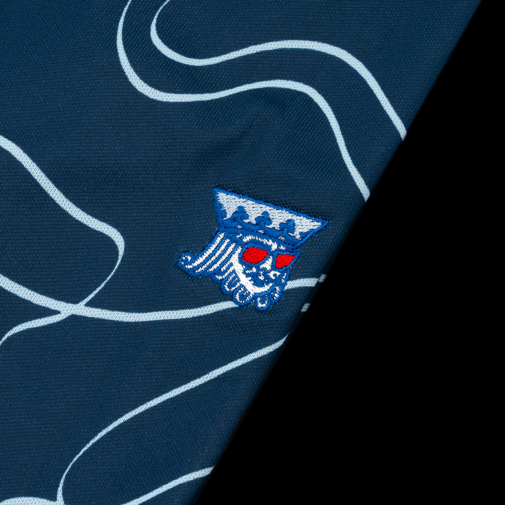 Navy Blue golf polo with light blue wave design and king logo on left chest.