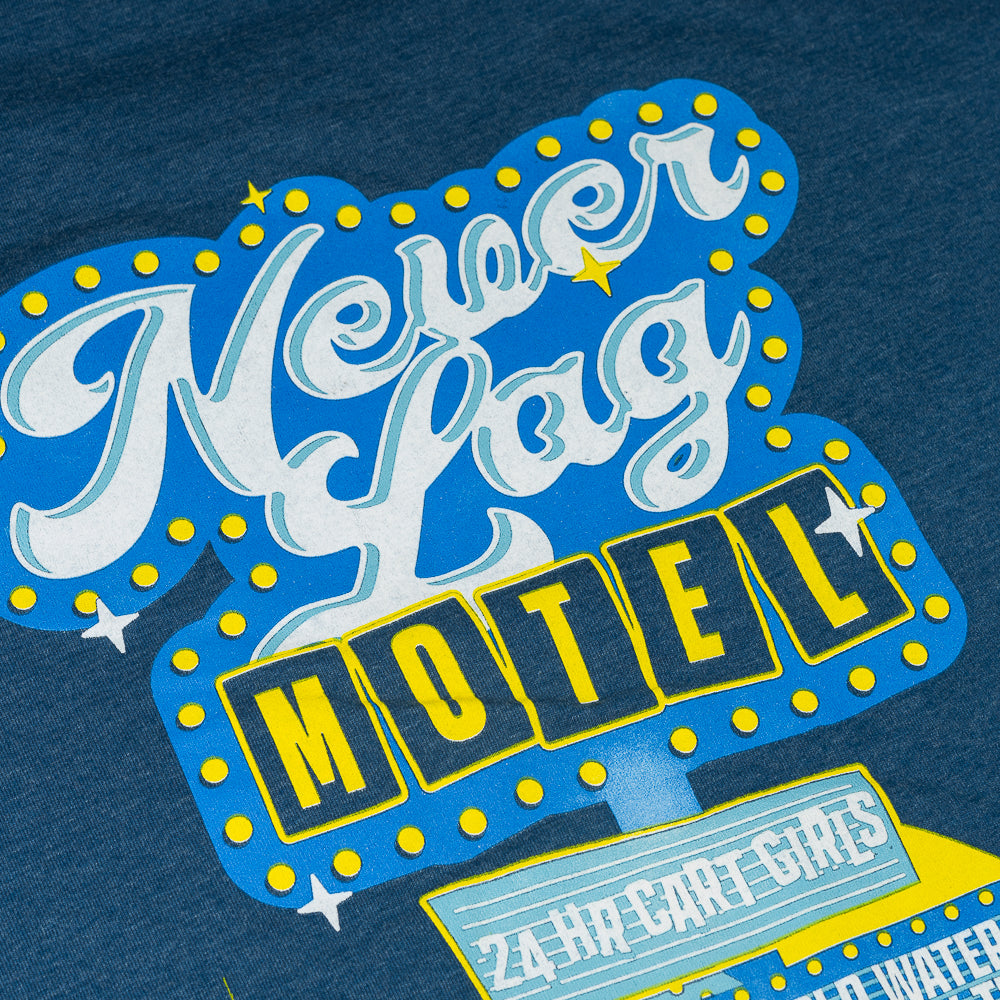 Close up on Never Lag Motel in blue and yellow.