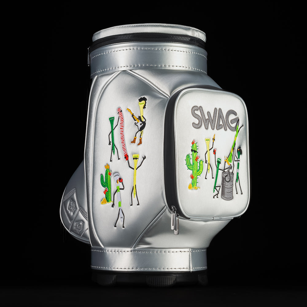 Alternate angled view of silver SWAG Golf Desert Tee Party Den Caddy displaying embroidered desert figures, cactus details, and structured pocket design.