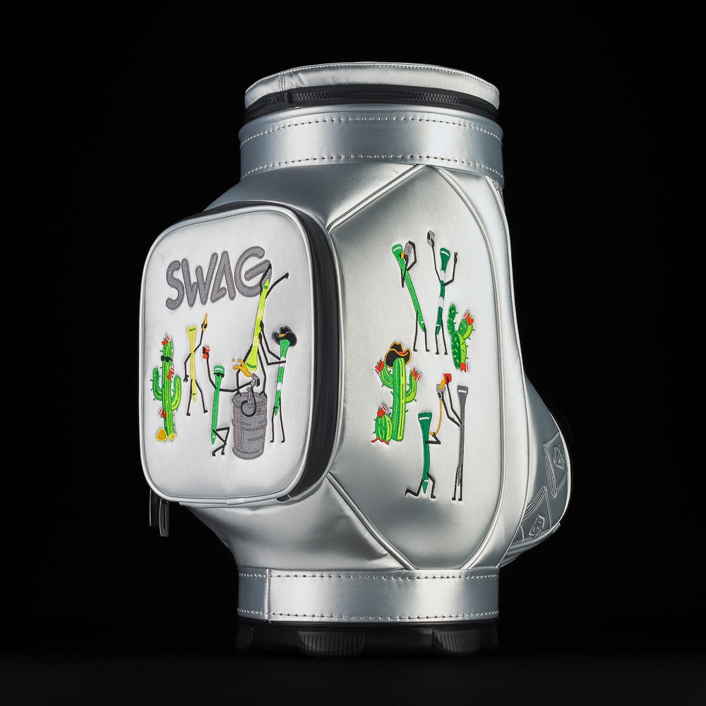 Angled side view of silver SWAG Golf Desert Tee Party Den Caddy highlighting side pocket embroidery with desert themed characters and golf tee graphics.