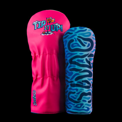 Back view of a driver and fairway cover. The driver features a "Tip it Up!" graphic on a neon pink background with the SWAG  logo. The fairway cover features a classic camo print with blue and pink details. 