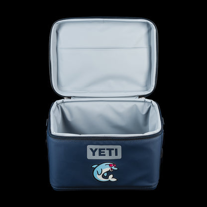 SWAG Golf x YETI Daytrip 9L insulated lunch box shown open, revealing the insulated interior and Flipper mascot graphic on the front.