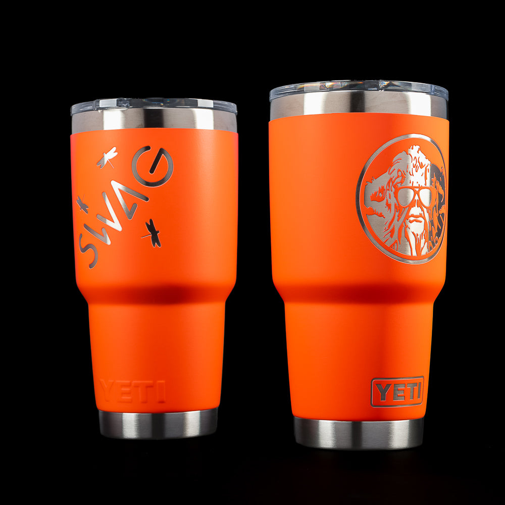 SWAG Golf x YETI Rambler 30 oz tumbler in Solar Flare orange featuring the SWAG logo with bugs on one side and the Swag Thing mascot graphic on the other.