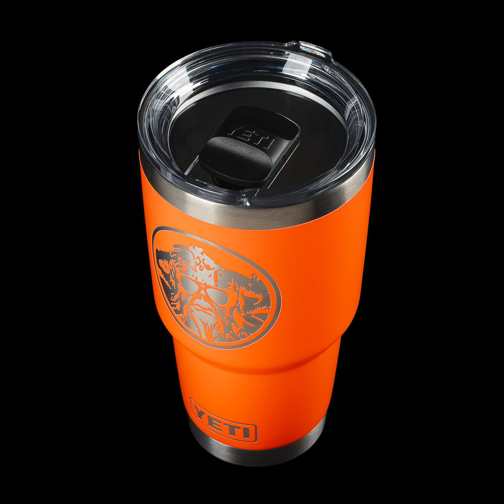 Angled top view of the SWAG Golf x YETI Rambler 30 oz tumbler with MagSlider lid, Solar Flare orange finish, and Swag Thing mascot graphic.