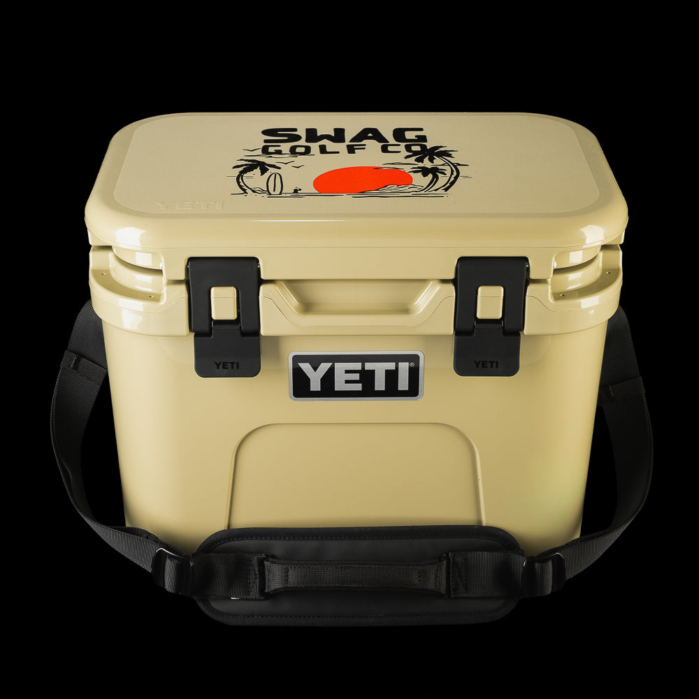 SWAG Golf x YETI hard cooler with carrying handle, showing the custom lid artwork and front YETI branding.