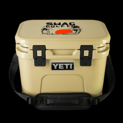 SWAG Golf x YETI hard cooler with carrying handle, showing the custom lid artwork and front YETI branding.