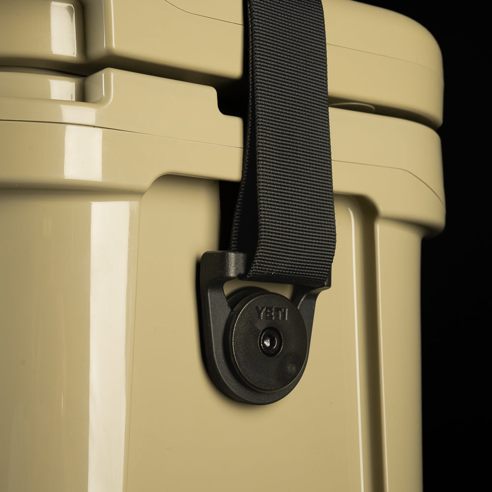 Close-up of the SWAG Golf x YETI cooler side showing the tie-down slot and handle.