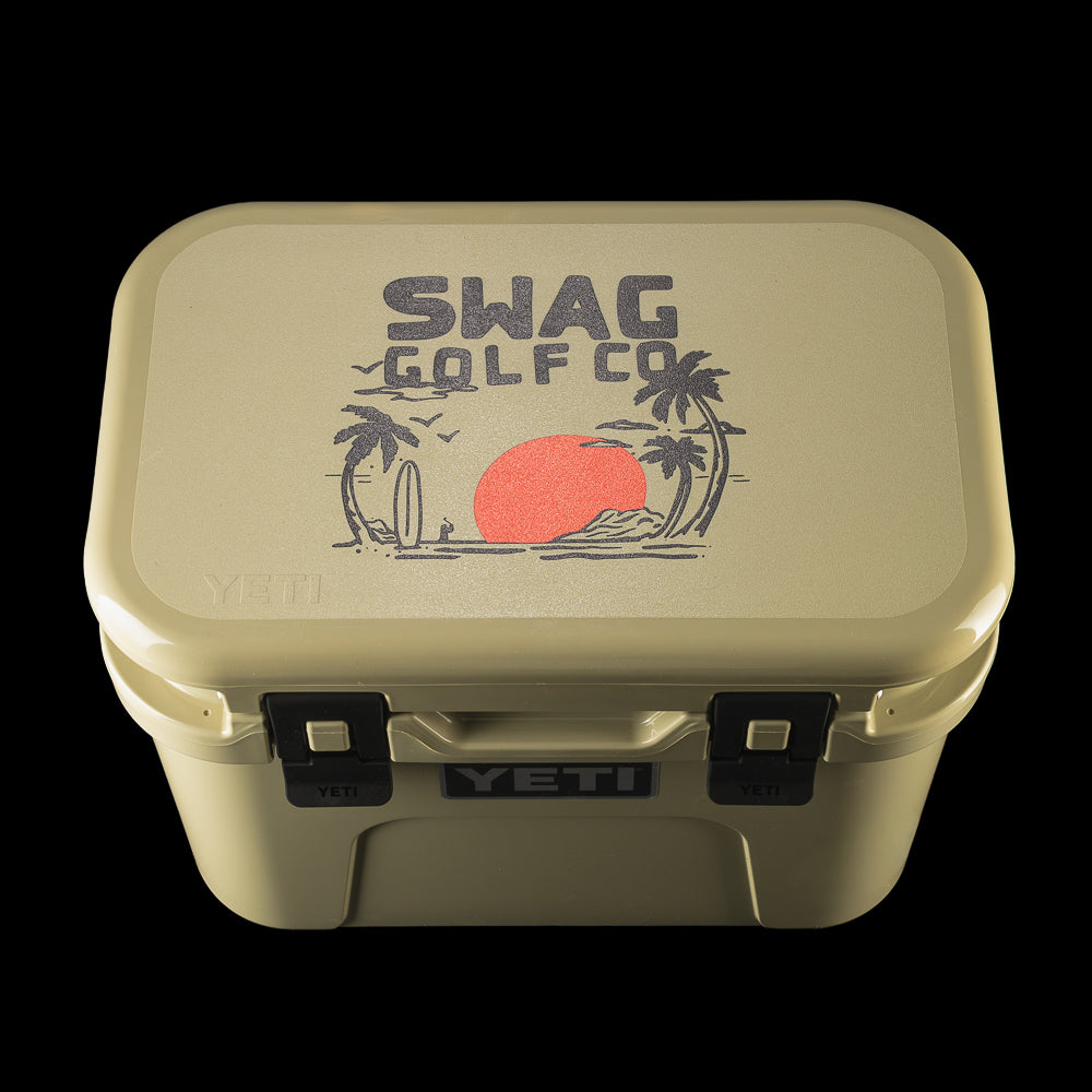 Top-down view of the SWAG Golf x YETI cooler displaying the SWAG Golf palm tree logo with a red sun graphic.