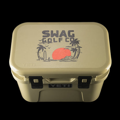 Top-down view of the SWAG Golf x YETI cooler displaying the SWAG Golf palm tree logo with a red sun graphic.