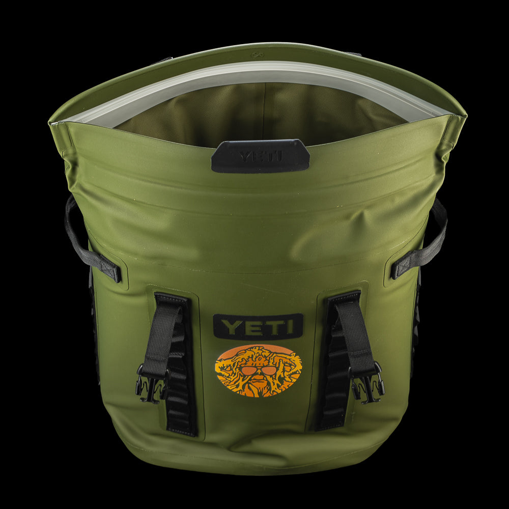 Top view of the SWAG Golf x YETI Hopper M20 backpack soft cooler showing the insulated interior and Swag Thing artwork on the front.