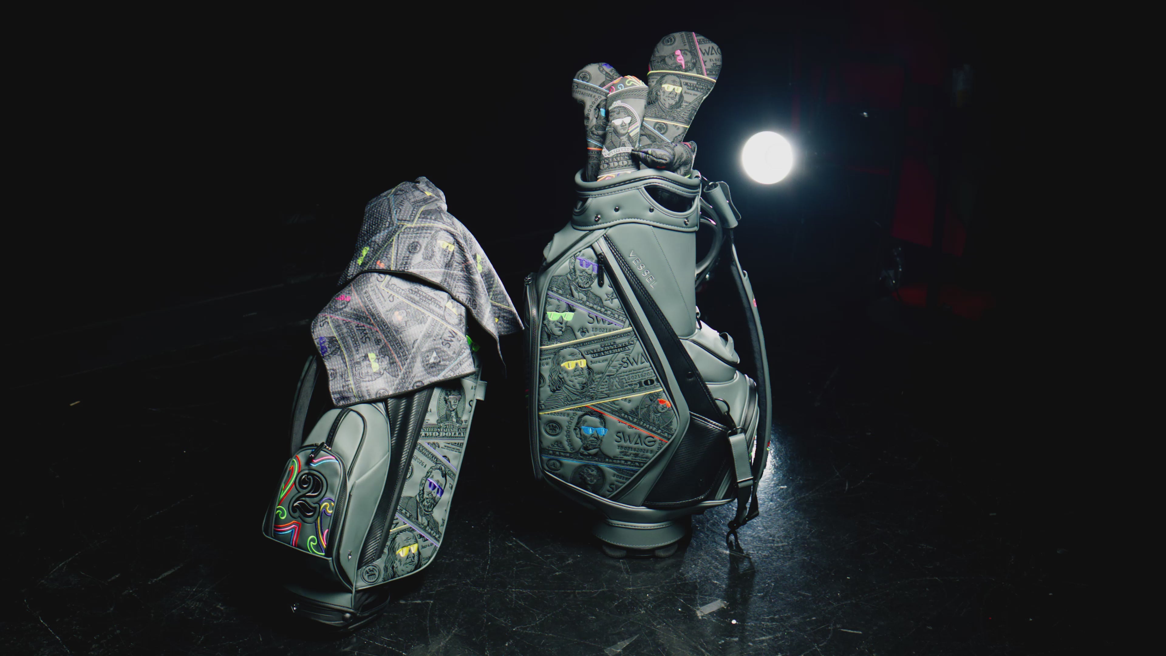 Load video: SWAG Golf Presidents Day collection featuring limited edition golf headcovers, putters, apparel, and accessories with a currency theme.