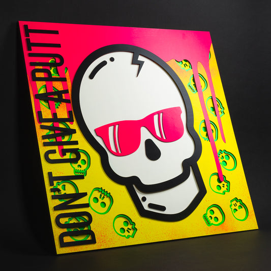 Swag x Andre Kaut Designs cnc baltic birch wood art panel featuring the signature Swag Don't Give A Putt skull with yellow, pink and green accents.